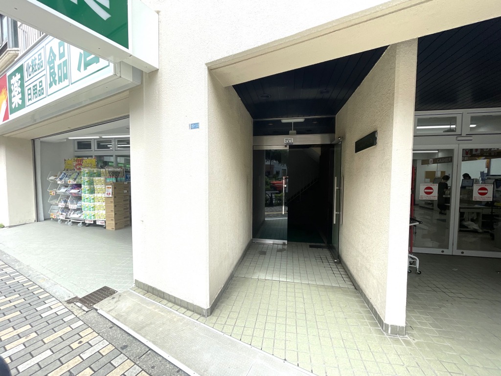 【エントランス】明治通り沿い側の少し奥まった位置にエントランスがあります。1階にはツルハドラッグが入っており、日常のお買い物に大変便利です。