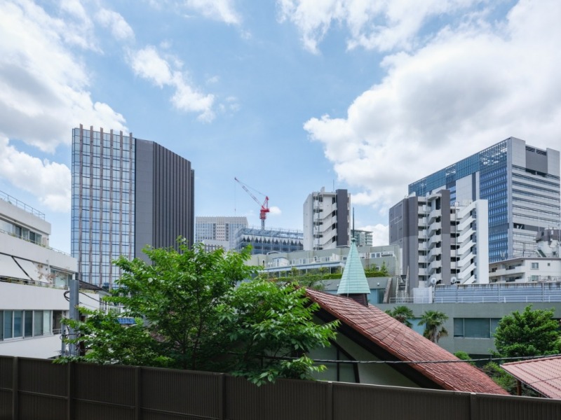 【バルコニーからの眺望】前面は低層の建物が多く、教会のグリーンが覗き、奥には、大崎方面のビル群が広がる眺望です。広い空も仰げます。