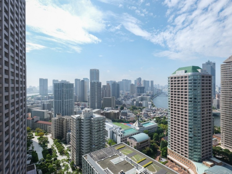 【住戸からの眺望】眼下にはグリーンも多く、奥には月島の街並みが一望でき、隅田川が流れ、湾岸エリアの方まで望めます。空も広く、空色の移ろいも感じられる眺望です。夜は、都心と水辺も美しいベイエリアの煌びやかな夜景も望めそうです。