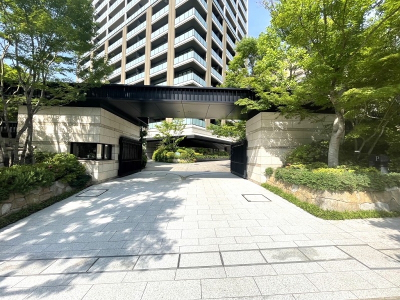 【エントランス】重厚でシックな高級感溢れるメインエントランスです。守衛室が置かれ、緑溢れるエントランスまでのアプローチには、車寄せもあります。