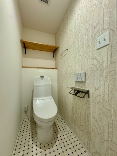 【トイレ】トイレはうれしい洗浄機能付きです。アイアン製のトイレットペッパーフォルダーや吊棚が設置されており、空間のアクセントとなっています。