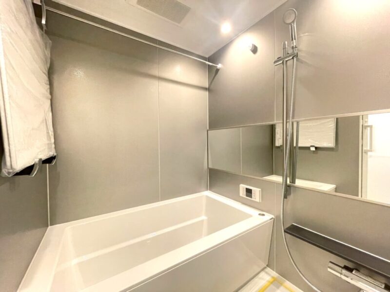 【浴室】グレイッシュな落ち着いた内装で、1418サイズのゆったりとしたリラックス空間となっています。保温性の高い専用の風呂ふたや空間を広く感じさせるワイドミラーも備えています。また浴室換気乾燥機付きで、バスタイムも快適です。室外干しができない梅雨や花粉の時期のお洗濯にも活躍します。